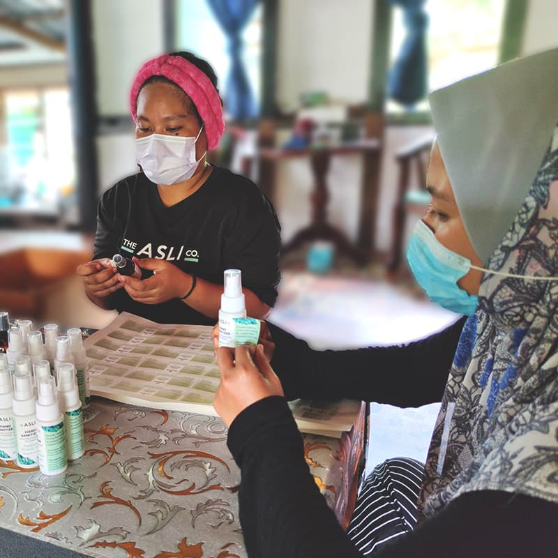 Orang Asli ladies working on sanitizer