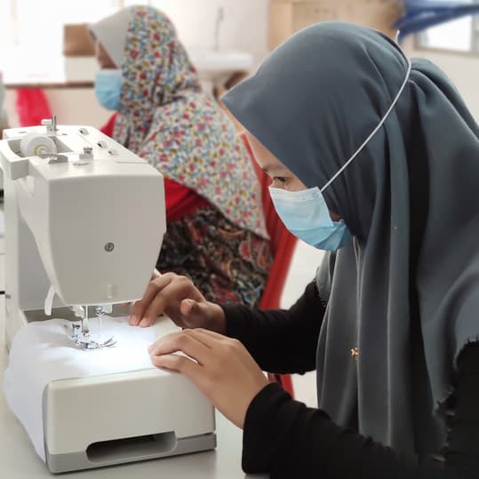 Orang Asli ladies making reusable face masks